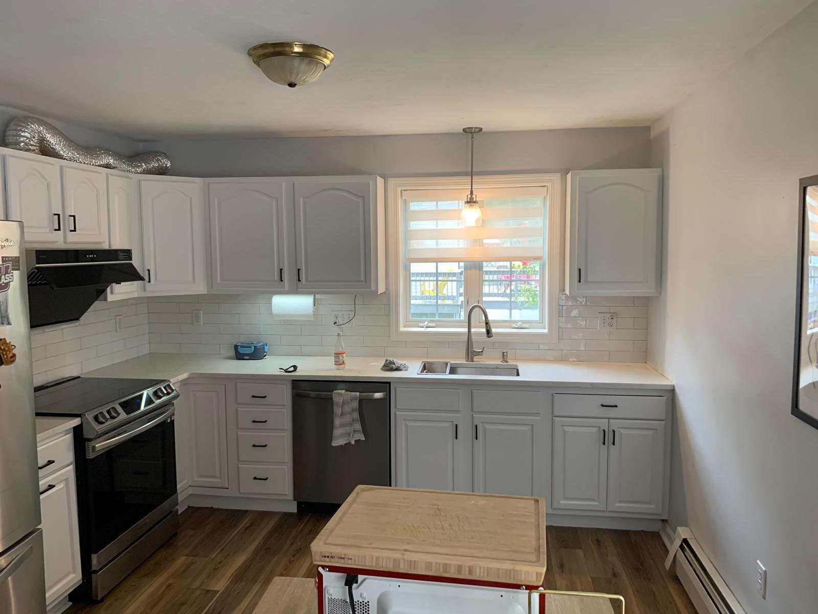 Renovated kitchen with white cabinets and subway tile backsplash